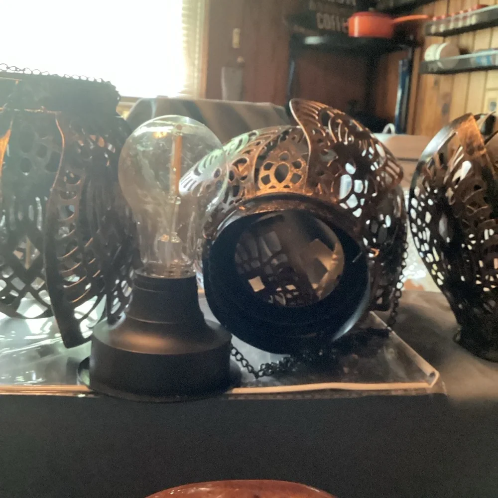 3 ornate tree lanterns outside
